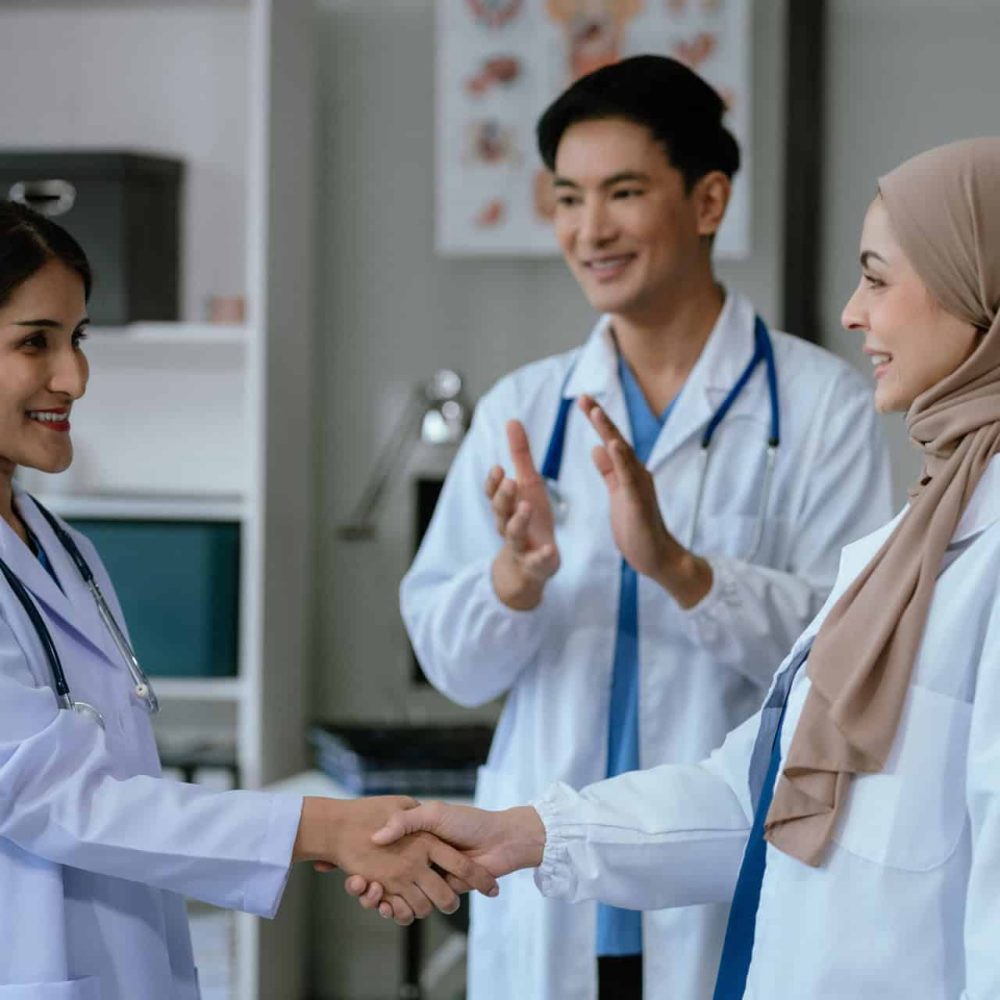 Doctor and Nursing assistant patient meeting at the hospital and shaking hands, healthcare and medicine banner in the morning.
