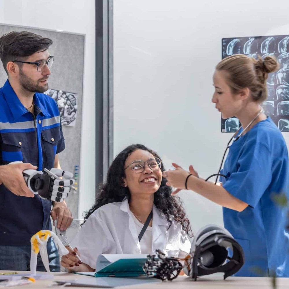 Robotic rehabilitation engineer work with an orthopedic doctor and a surgeon to create somatosensory robotic arms and hands for patients requiring advanced prosthetics or rehabilitation support.