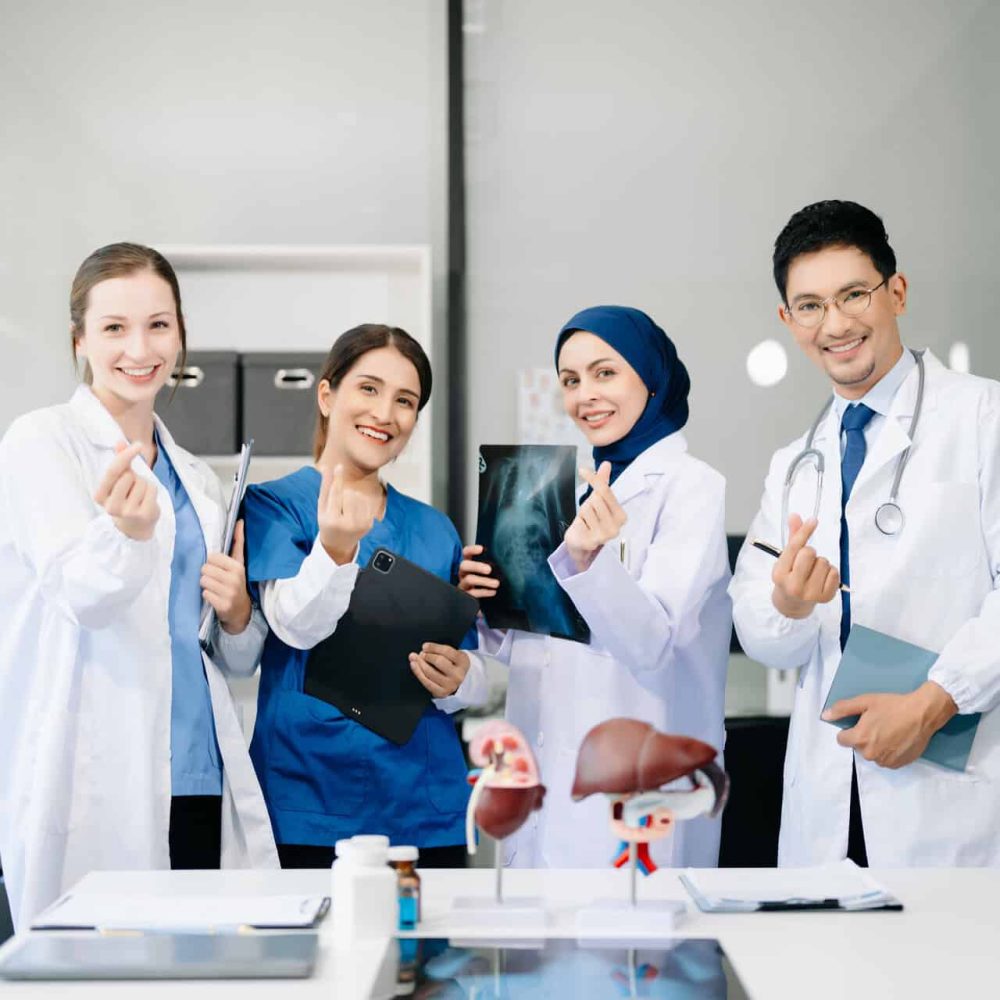 Successful team of medical doctors looking at camera and smiling while standin. Health, professional and people team in office hospital